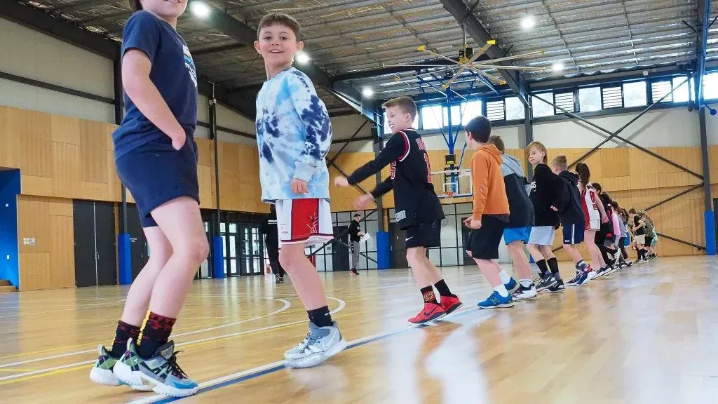 Young players lined up for a skills drill in the stadium