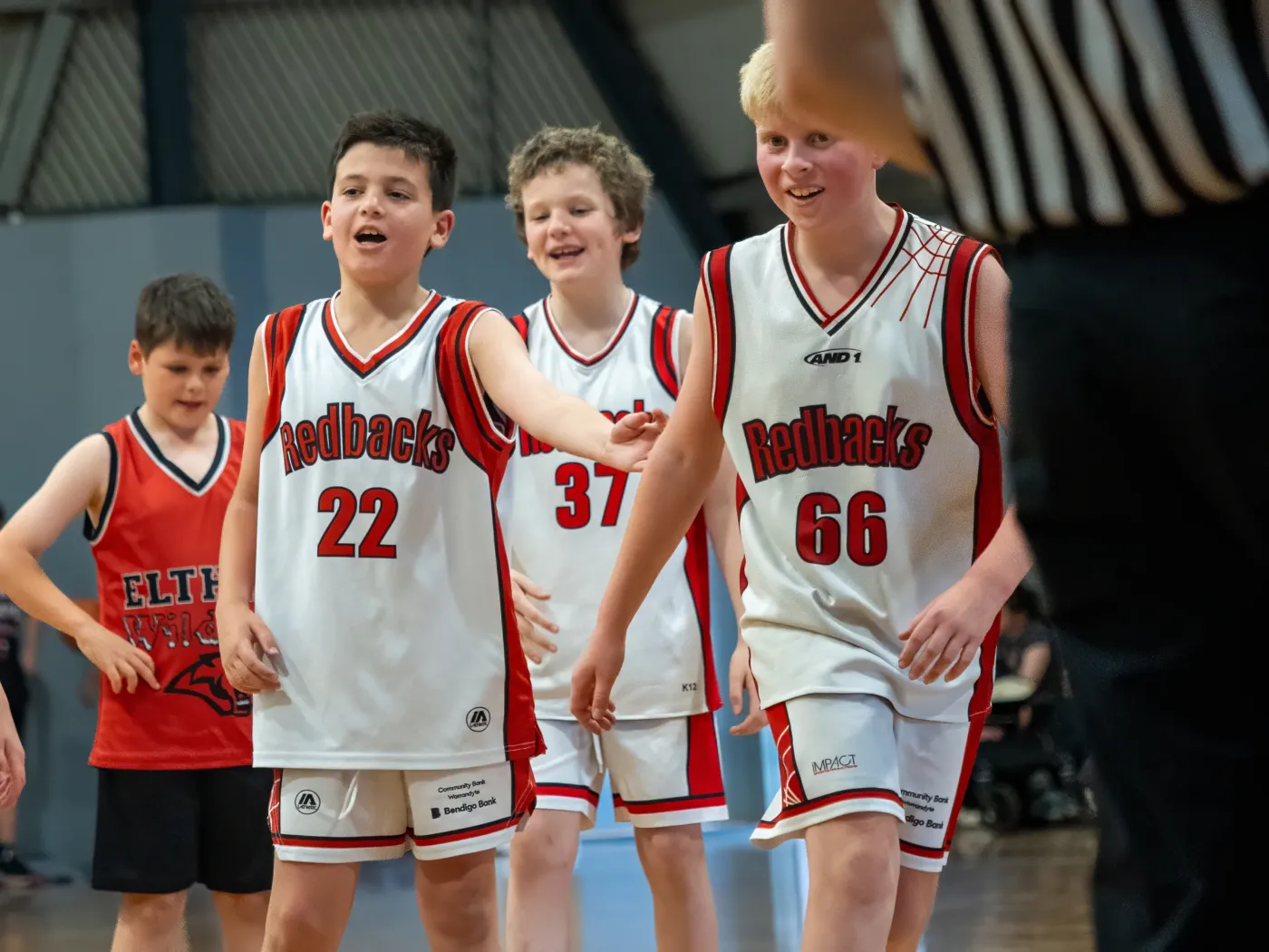 Three Redbacks teammates laughing together on court
